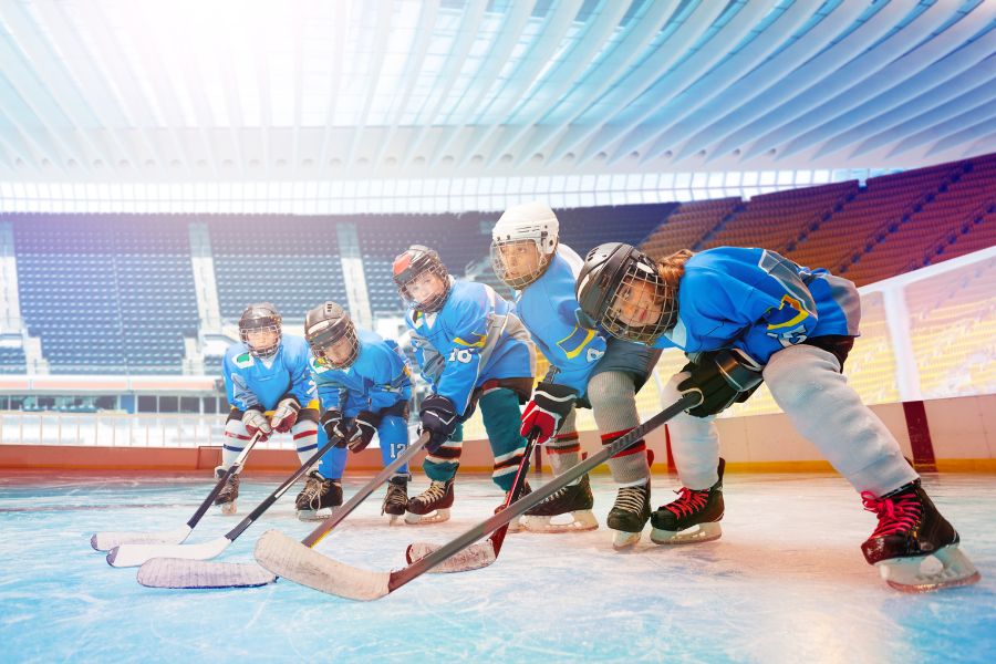 Hockey team of happy boys and girls in team uniform