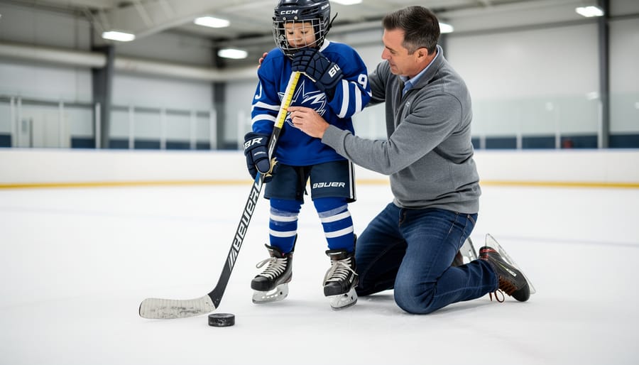 Close-up of gloved hands adjusting the fit of a youth ice hockey stick